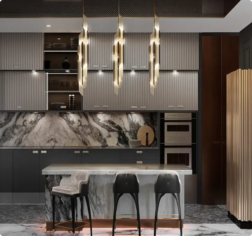 Modern kitchen with marble island and stacked gray cabinets, illuminated by hanging gold pendant lights.