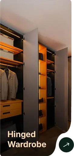 Open hinged wardrobe with hanging clothes, shelves and a drawer, lit by warm orange lighting; overlay text reads “Hinged Wardrobe”