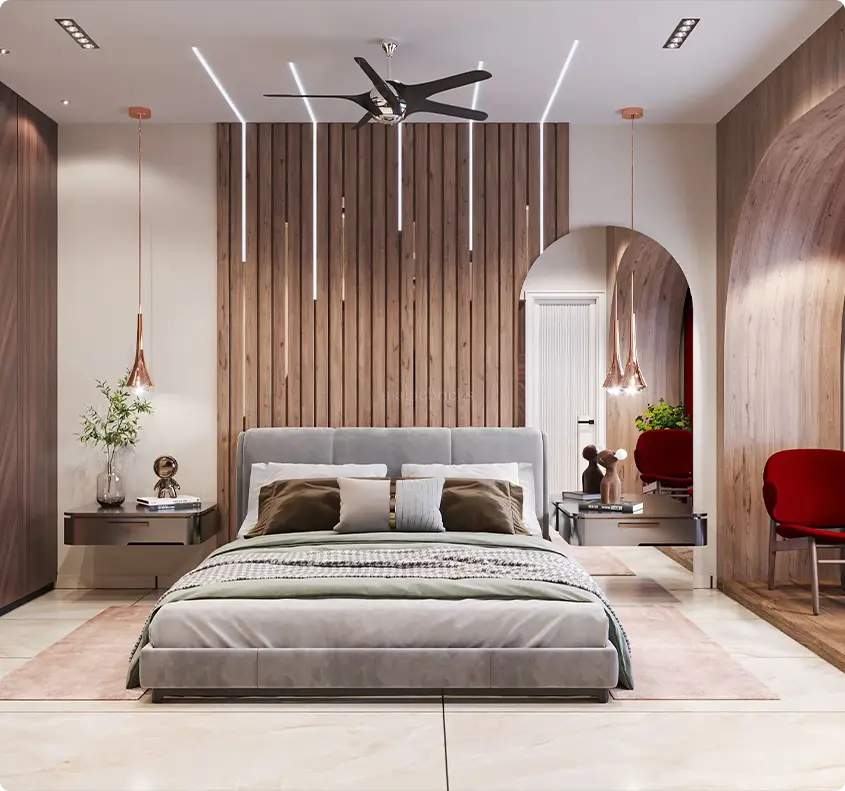 Modern bedroom with a gray upholstered platform bed, wooden slat accent wall, and vertical pendant lights over a soft pink rug.