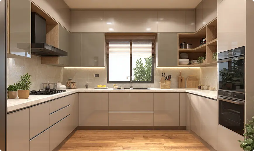 L-shaped modern kitchen with beige handleless cabinets, marble countertops, and a window above the sink.